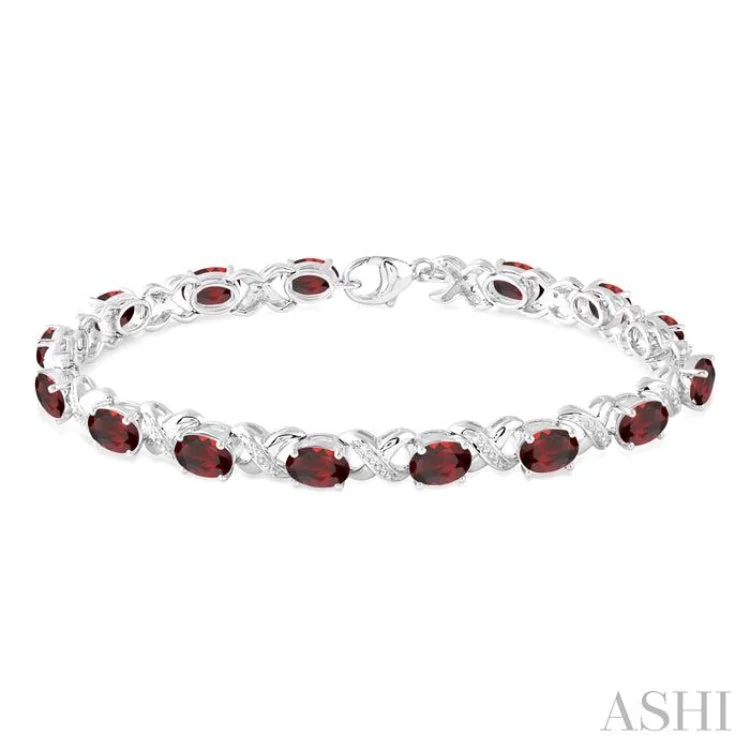 big statement bracelets for women -7x5 mm Oval Cut Garnet and 1/20 Ctw Round Cut Diamond Fashion Bracelet in Sterling Silver