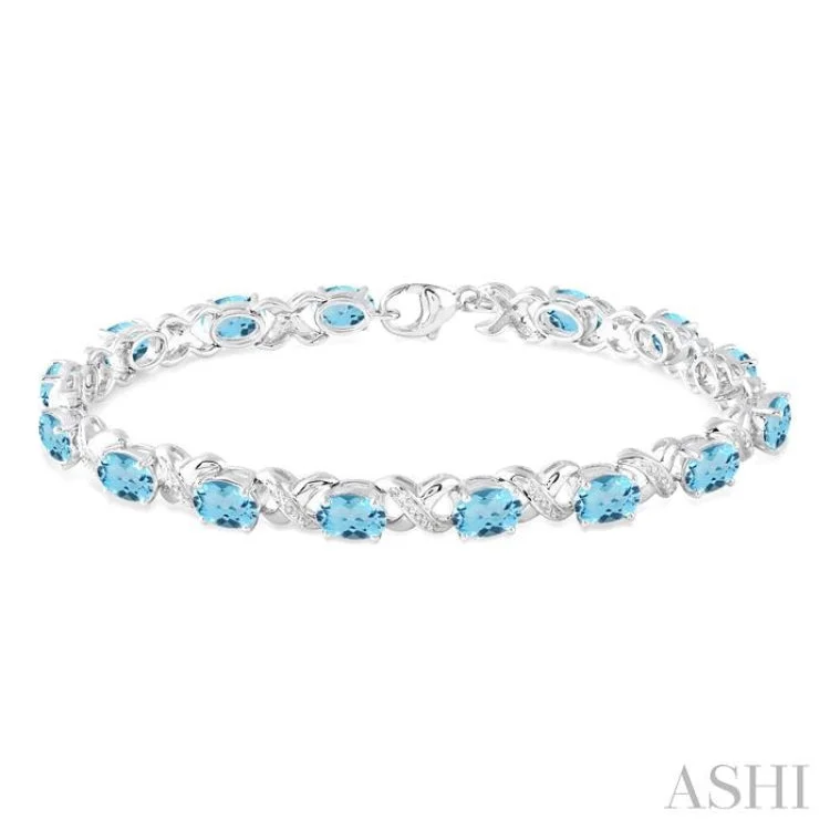 chunky bracelets for women -7x5 mm Oval Cut Blue Topaz and 1/20 Ctw Round Cut Diamond Fashion Bracelet in Sterling Silver