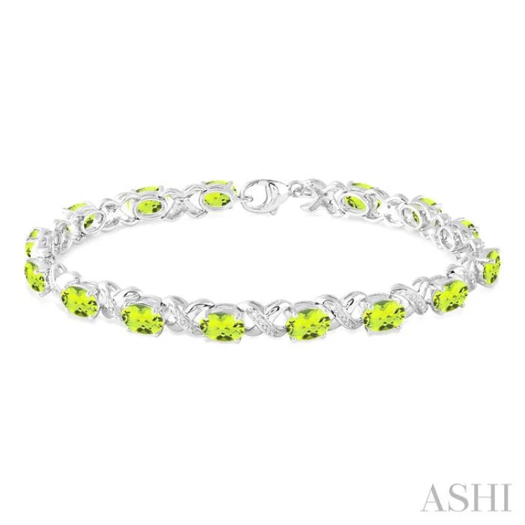 stackable bracelets for women -7x5 mm Oval Cut Peridot and 1/20 Ctw Round Cut Diamond Fashion Bracelet in Sterling Silver